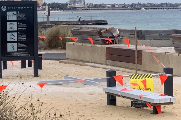 A person reads a book at Middle Park foreshore on Wednesday.