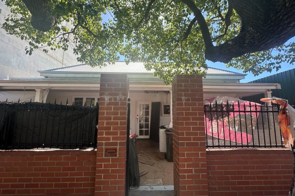 The Northbridge home is now draped with plastic, fabric and tarpaulins.