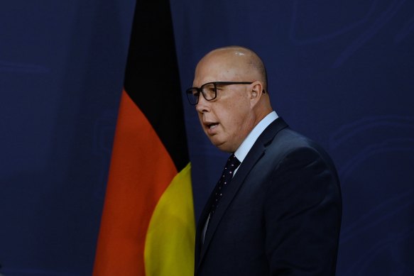 Opposition Leader Peter Dutton at a press conference in Sydney last year with the Aboriginal flag behind him.