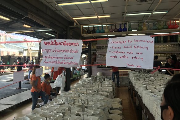 Signs remind visitors to maintain social distancing at the Chatuchak Weekend Market.