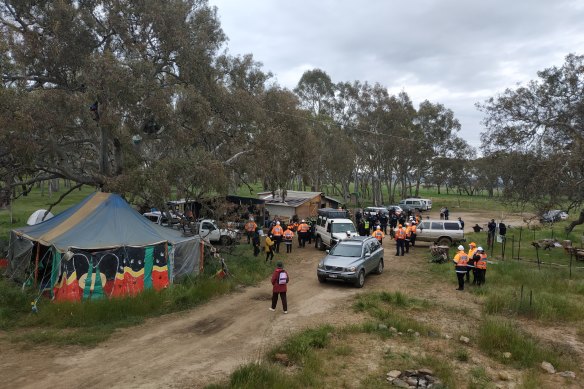 Police officers and roads workers move into the Djab Wurrung site on the Western Highway on Tuesday morning.