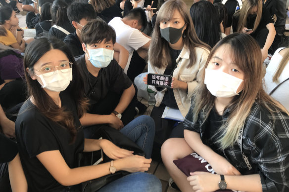 Students gather outside West Kowloon Magistrates Court as 100 protesters face charges.