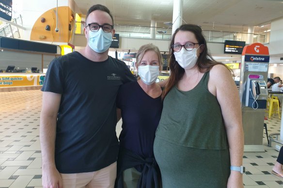 Kimberley Jones (centre) was reunited with her son Tyler Jones and daughter-in-law-to-be Maddie Blue at Brisbane Airport.