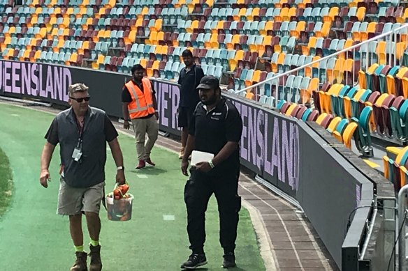 Ground staff at the Gabba check a new video cabling system allowing extra fence signage flexibility for advertisers.