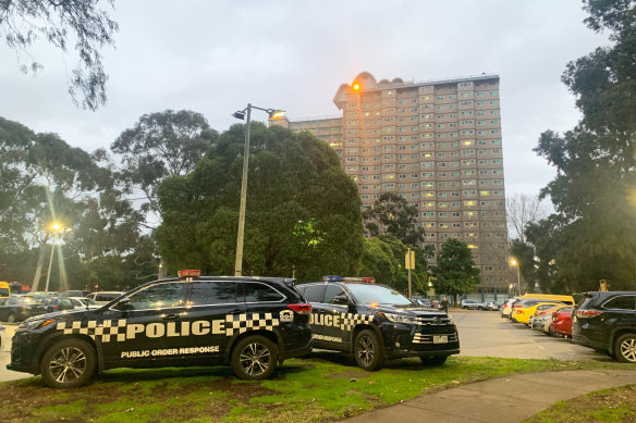 Police outside the public housing towers on Racecourse Road, Flemington.