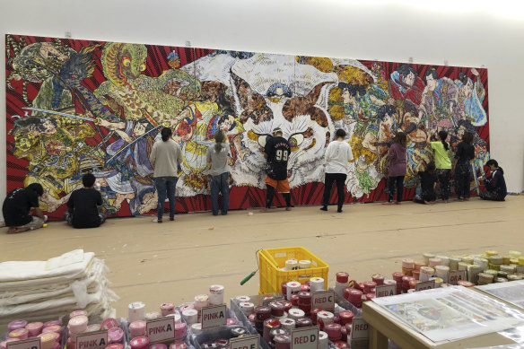Staff at Takashi Murakami’s studio in Saitama, Japan, work on the detailed decorative surface of Murakami’s new work for the Art Gallery of NSW.