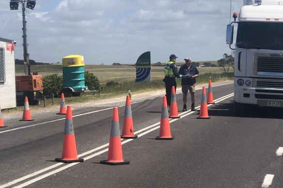 Police at the South Australia-Victoria border post near Nelson on Wednesday.