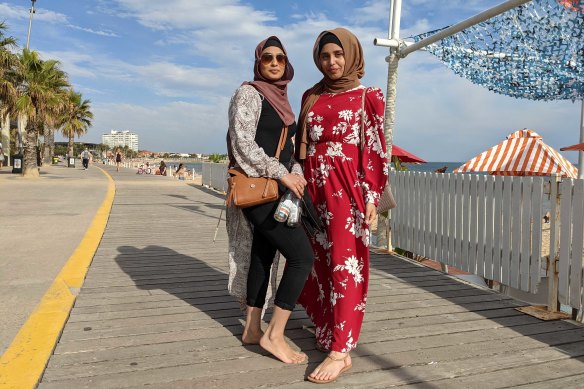 Friends Saba (left) and Iqra meander along the St Kilda boardwalk on Thursday.