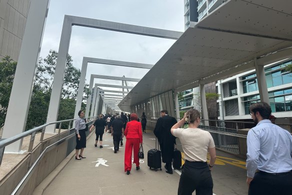 Pedestrians streamed over the Kurilpa Bridge after the law courts were evacuated.