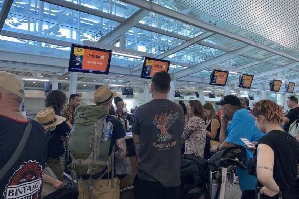 People queue at Denpasar Airport in Bali to board Jetstar flights bound for Australia.