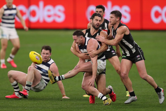 Geelong's Jack Steven manages to get boot to ball.