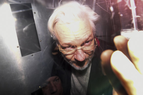 Julian Assange leaves in a prison van after appearing in a London court last year.