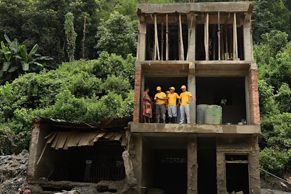 Rescue teams pick through the wreckage of a building in Dhunge.