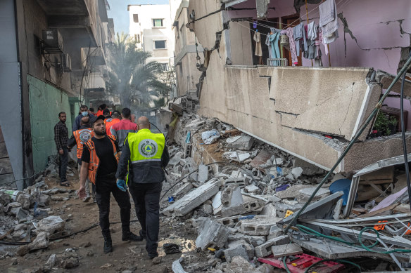 Palestinian civil defence members search for people in the rubble of a destroyed building after an Israeli air strike in Gaza City on May 16.