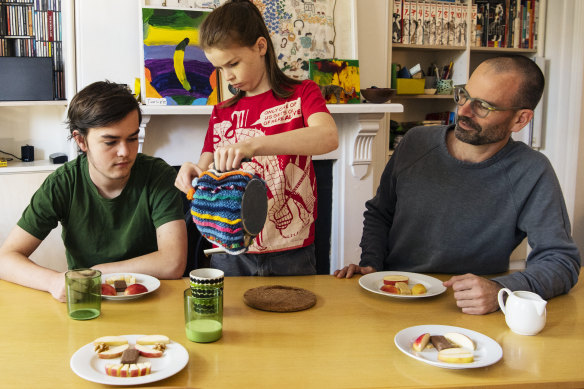 Artist and academic Stefan Lie having afternoon tea, during lockdown with children Rolf and Tino at their Bondi Junction home. 