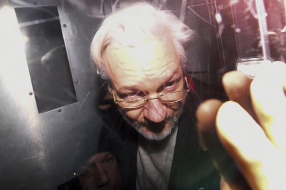 Julian Assange leaves in a prison van after appearing in a London court in January.