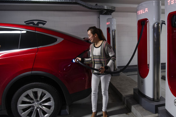 Vicky Wang charges her electric car at a Tesla station in the Broadway shopping centre in inner Sydney.