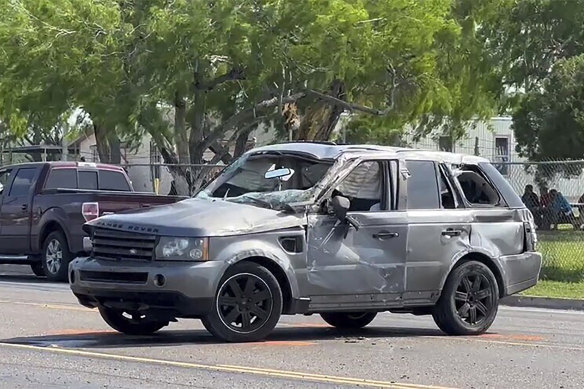 A damaged vehicle sits at the site of a deadly collision near a bus stop in Brownsville, Texas.