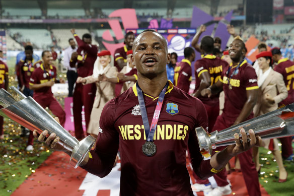 Marlon Samuels celebrates helping the West Indies retain their World T20 crown, four years after a career highlight innings in the 2012 final.