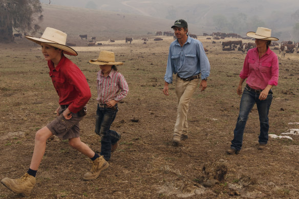 Nicki and James Pearce with their children Harry, 10, and Lily, 7, on their farm at Yaven Creek which was hit by bushfires in January. 