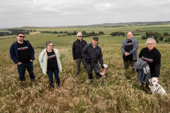 Mitchell Shire councillor Rob Eldridge (third left) with locals (from left) James Cisco, Skye Forster, Mike Phillips, Gazza Sturdy and Gayle Phillips on Green Hill in Wallan. Spring Hill and the proposed quarry site is in the background.