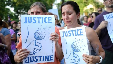 Betsy Custis, right, and others attend a march in honour of Justine Damond at Beard's Plaisance Park in Minneapolis.