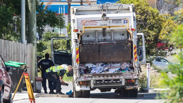 Police inspecting a garbage truck that was involved in the death of a woman on Moonramba Road, Dee Why, on 8 February 2018. 
