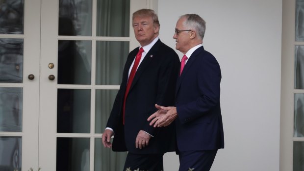 Donald Trump and Malcolm Turnbull walk along the colonnade for their meeting in the Oval Office.