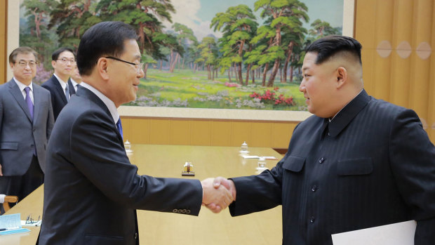 North Korean leader Kim Jong-un shakes hands with South Korean National Security Director Chung Eui-yong after Chung gave Kim a letter from South Korean President Moon Jae-in.