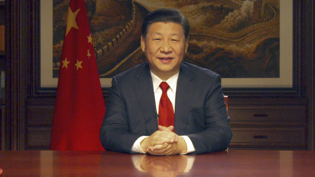 Chinese President Xi Jinping delivers a New Year speech broadcast on state television in Beijing.
