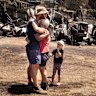 CFA volunteer Raewyn Rice greets her son after fighting fires all night and returning to her own home to find it was a twisted, blackened ruin.