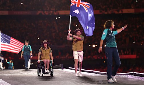 Lauren Parker and James Turner as flag-bearers at the closing ceremony.