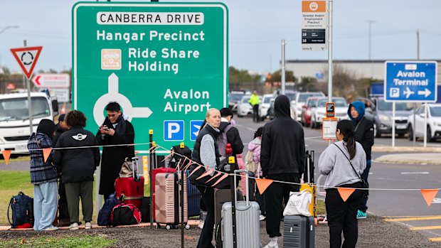 Travellers wait outside Avalon Airport after it was evacuated over a bomb threat.