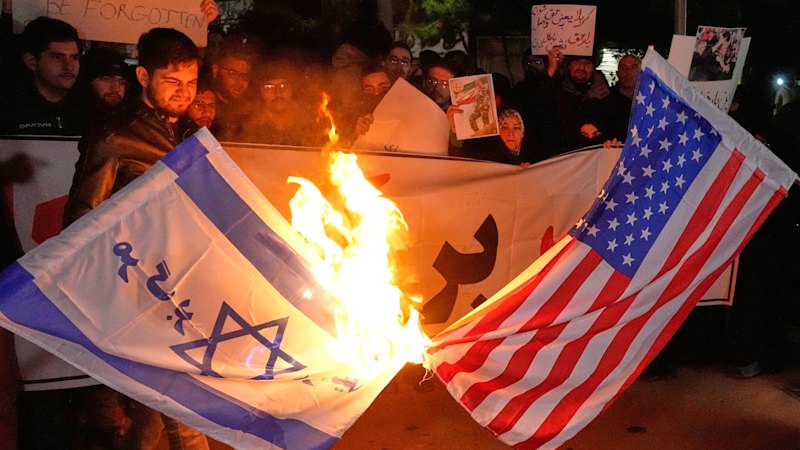 Iran warns of retaliation if Trump strikes, as US withdraws personnel from bases