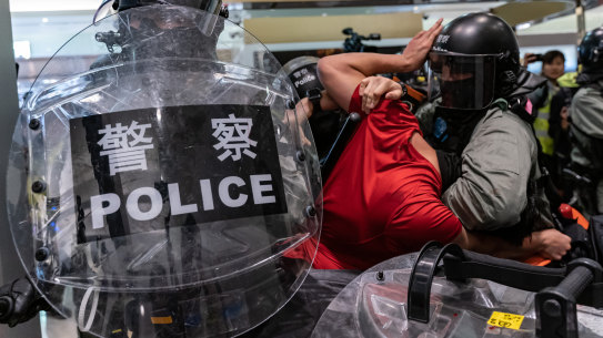 A man is detained by riot police during a demonstration in a shopping mall at Sheung Shui district on December 28. Protesters have been targeting commercial centres during the Christmas period.