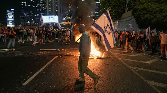 Israelis light a bonfire during a protest after Yoav Gallant was sacked as defence minister.