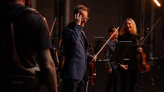 Richard Tognetti and principal violin Satu Vanska during a filming of an ACO StudioCast at Sydney's Carriageworks.