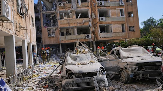 Israeli security forces inspect a destroyed building that were hit by a missile fired from Iran, in Holon, near Tel Aviv, Israel.