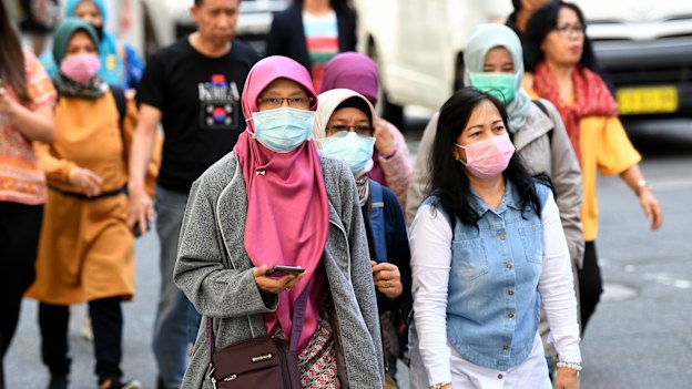 People wearing face masks in Sydney on Friday.