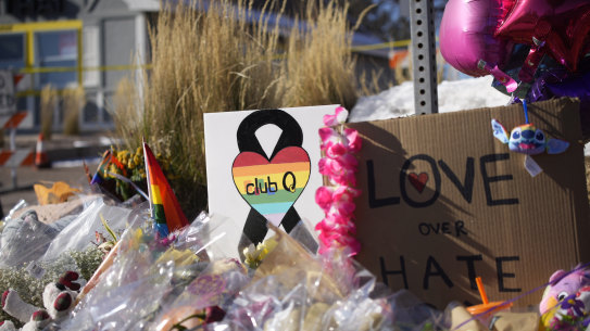 Bouquets of flowers sit on a corner near the site of a mass shooting at a gay bar in Colorado Springs, Colorado.
