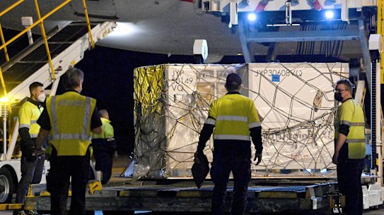 Airport workers unload pallets of the first shipment of the Moderna COVID-19 vaccination as it arrives in Sydney, Australia, Friday, Sept. 17, 2021