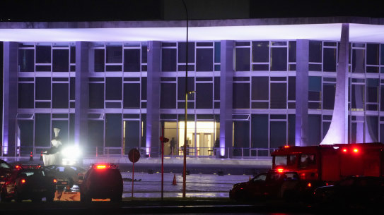 Police vehicles are parked outside the Supreme Court in Brasília, Brazil, following an explosion.