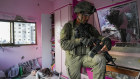 An Israeli soldier stands in an apartment during a ground operation in the Gaza Strip.