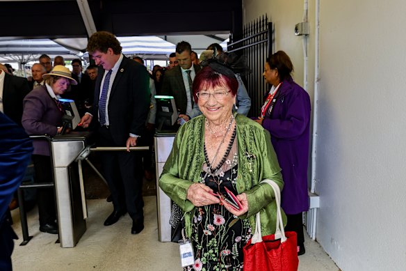 A happy racing fan arrives through the gates.