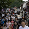 The ascent of the masses, as visitors walk the sloping streets to the Kiyomizu-dera Temple.