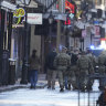 Military personnel walk down Bourbon street on Thursday in New Orleans.