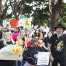 Attendees at the No More: National Rally Against Violence walked past areas fenced off due to asbestos contamination in Belmore Park in Haymarket. 