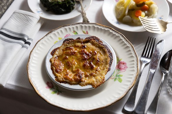 Braised baby goat is hidden beneath cheese and eggplant puree.