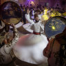 Whirling Dervishes and traditional performers dance during the mens wedding party of Mr. Muwaffaq Al-Badawi at a wedding hall in Damascus, Syria.