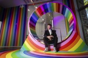 Melbourne University Science Gallery director Ryan Jefferies sitting on ‘Wheel’, by Hiromi Tango and Dr Emma Burrows. 